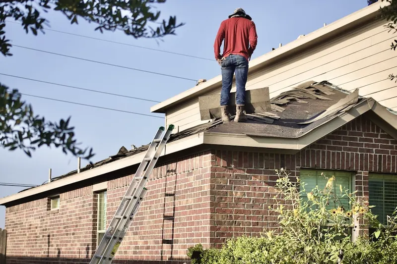 Professional roofer working on a residential roof in Clover Creek